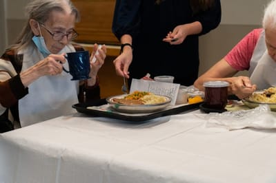 Residents enjoying a meal together in the dining area