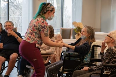 Staff member engaging with residents in a common area
