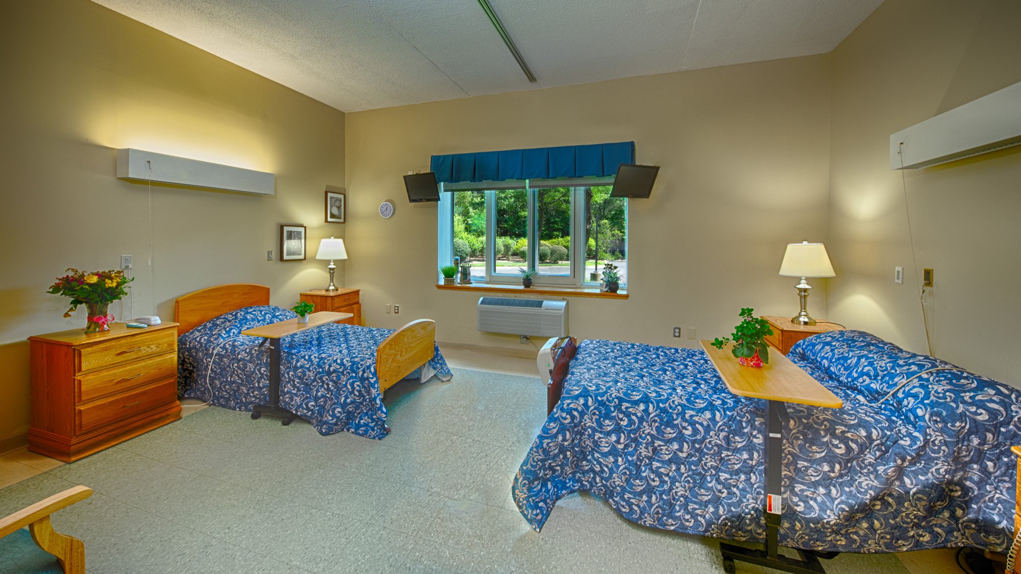 A cozy shared bedroom with two beds and floral decor