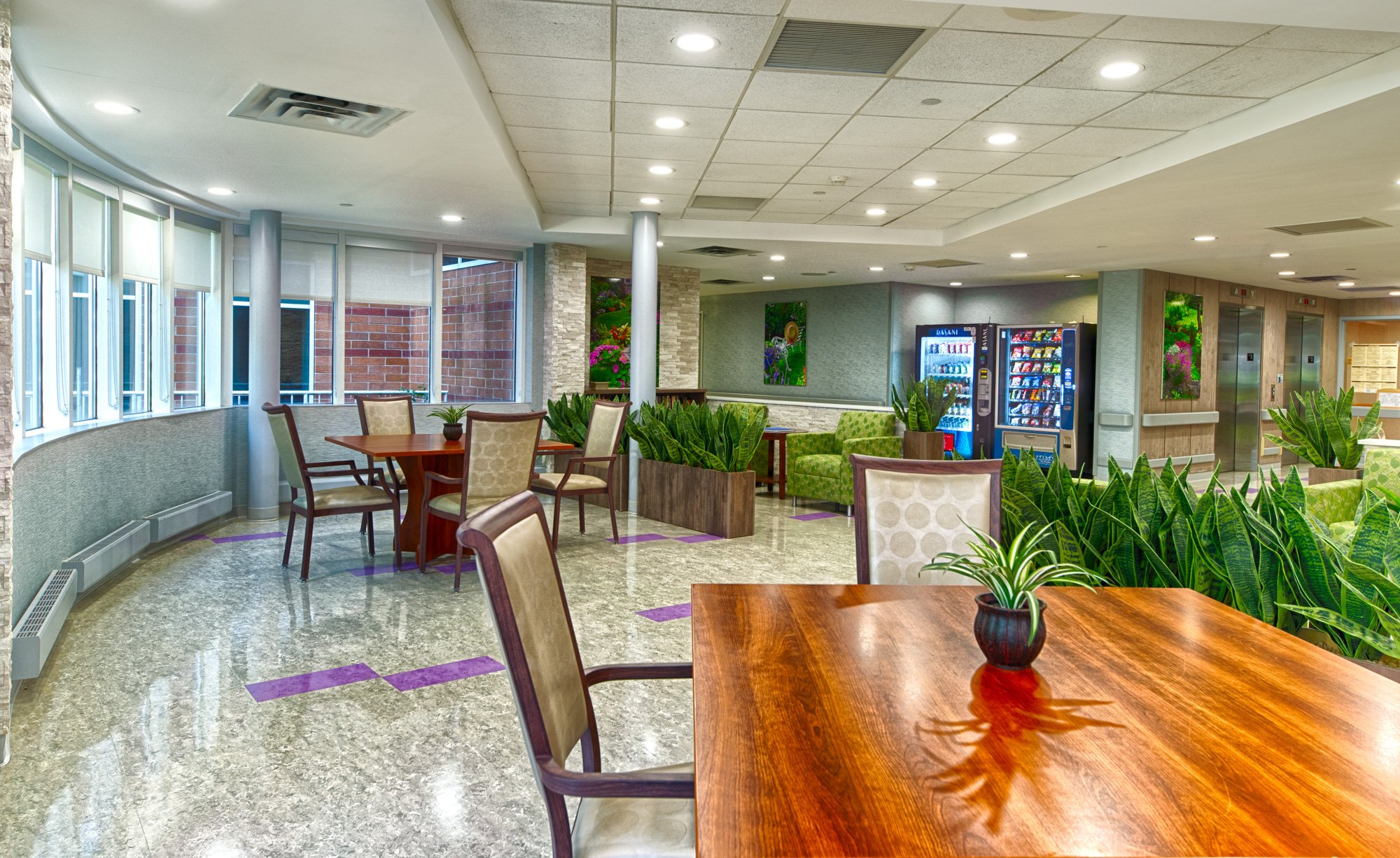 Bright common area with tables and plants