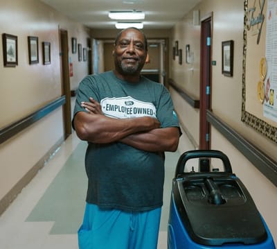 A staff member posing confidently in a corridor