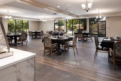Dining area with tables and chairs in a spacious room