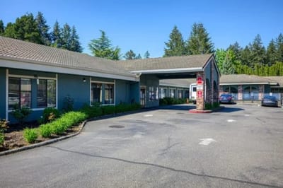Exterior view of a senior living facility with parking