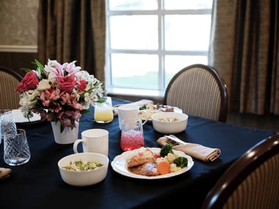 Dining table set with food and flowers