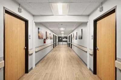 A bright hallway with resident rooms and artwork
