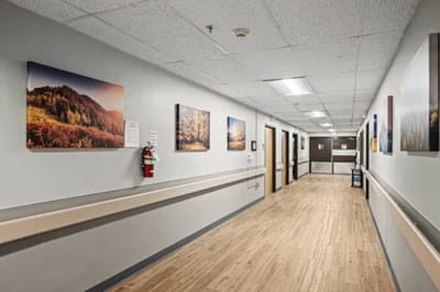 A hallway with framed nature photographs on the walls