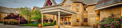 Exterior view of a senior living facility with landscaping