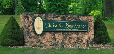 Sign for Christ the King Manor retirement community