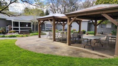 Covered outdoor seating area with tables and chairs