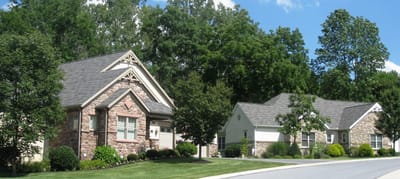 Exterior view of multi-unit residential buildings surrounded by trees
