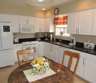 Well-equipped kitchen with dining table and flowers