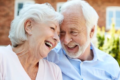 A happy elderly couple laughing together
