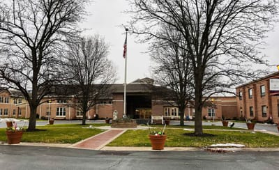 Exterior view of a senior living facility with landscaping