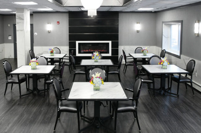 Dining area with table settings and flowers