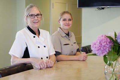 Staff members smiling in a modern dining area