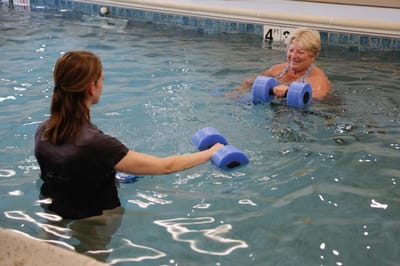 Residents participating in a water aerobics class