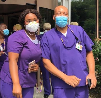 Staff members smiling outside the facility