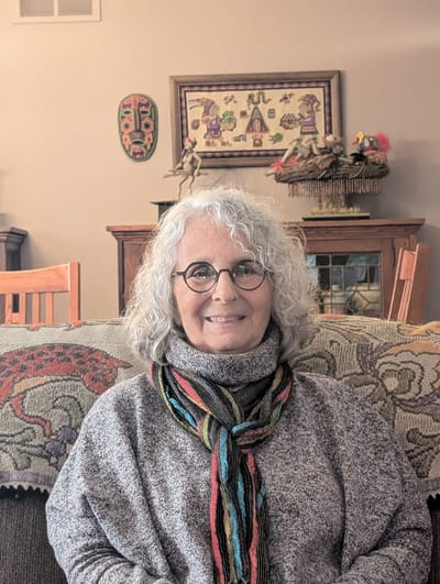A resident smiling in a cozy living area
