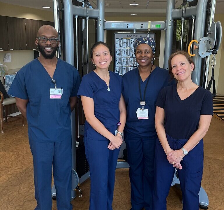 Staff members posing in a common area of the facility