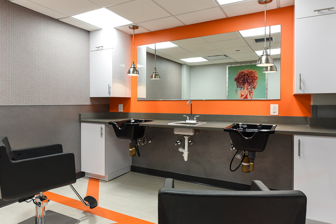 Hair salon interior featuring salon chairs and mirrors