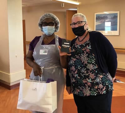 Staff member presenting gift to a resident