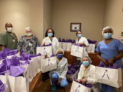 Staff gathering in a common area with gift bags