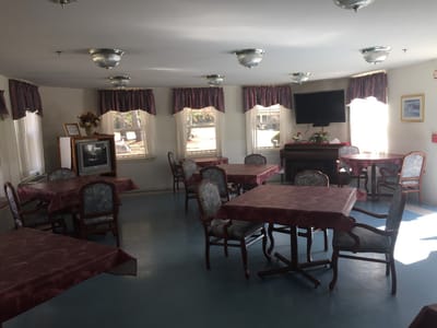 Dining room with tables and chairs in bright lighting