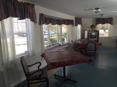 Interior view of a cozy common area with tables and chairs