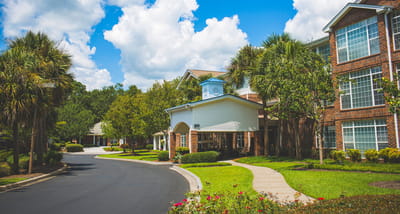 Pathway leading to a senior living facility with landscaping