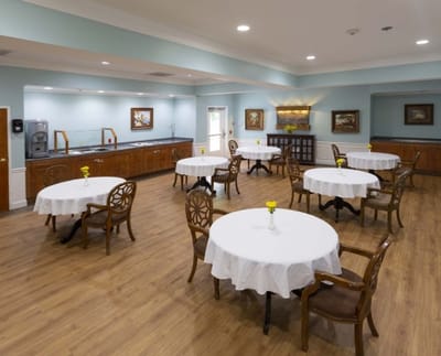 Bright dining room with tables and flowers