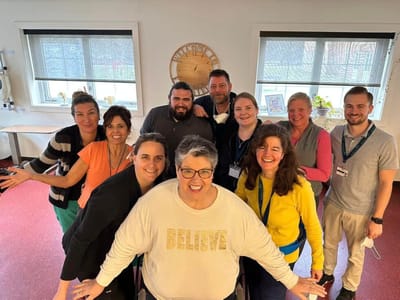 Staff posing together in a bright common area