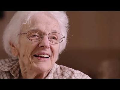 Senior woman smiling in a bright indoor setting