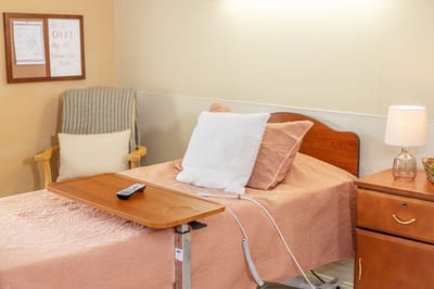 Cozy resident room with a bed and wooden furniture