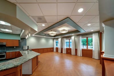 Bright common area with large windows and modern decor