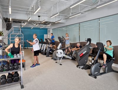 Residents exercising in a modern fitness room