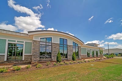Exterior view of a senior living facility with landscaping