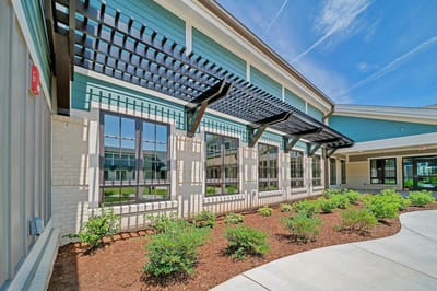Exterior view of a senior living facility with landscaping