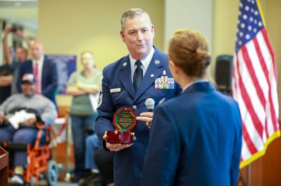 Ceremony honoring a veteran in a common area