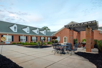 Outdoor patio area with seating and gardens