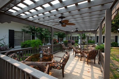 A cozy outdoor seating area with floral decor