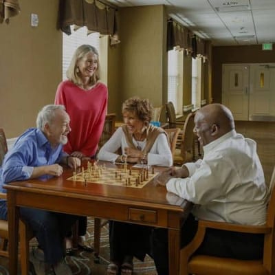 Residents enjoying a game of chess in a common area