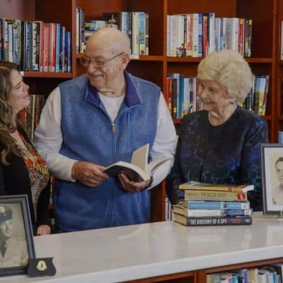 Residents and staff engaging in a library corner