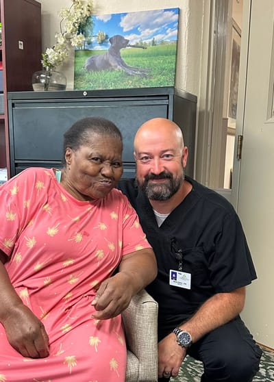 Resident and staff member posing for a photo
