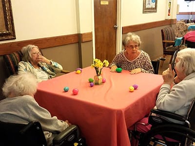 Residents engaged in an Easter activity around a table