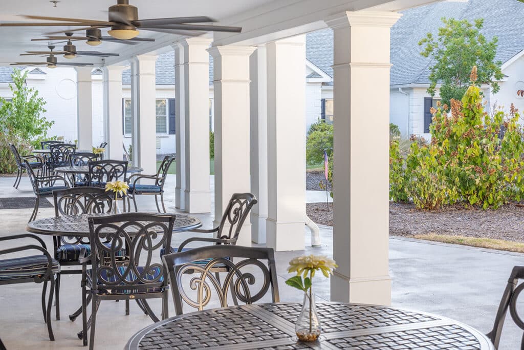 Covered outdoor seating area with tables and chairs