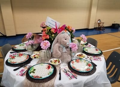 Table set with floral arrangements and decorative items