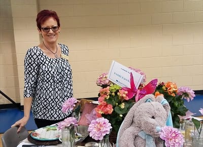 Staff member at a beautifully decorated event table