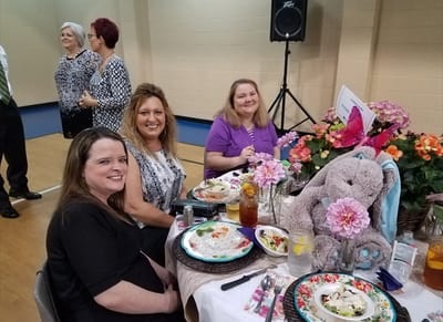 Residents enjoying a meal together at a dining table
