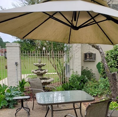 Outdoor seating area with patio umbrella and fountain