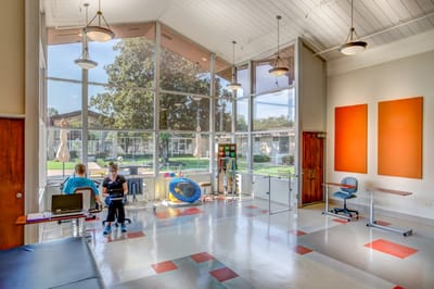 Interior of a bright common area with residents and staff